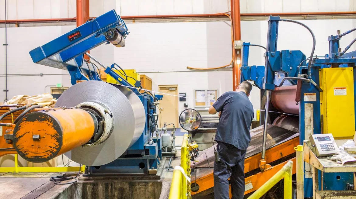 Chemcoaters Employee Processing Metal Coil.jpg