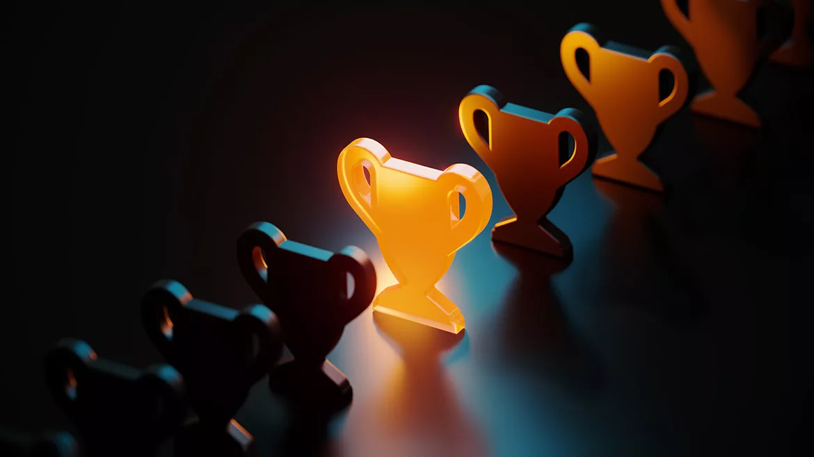 Trophy symbol glowing amid black trophy symbols on black background