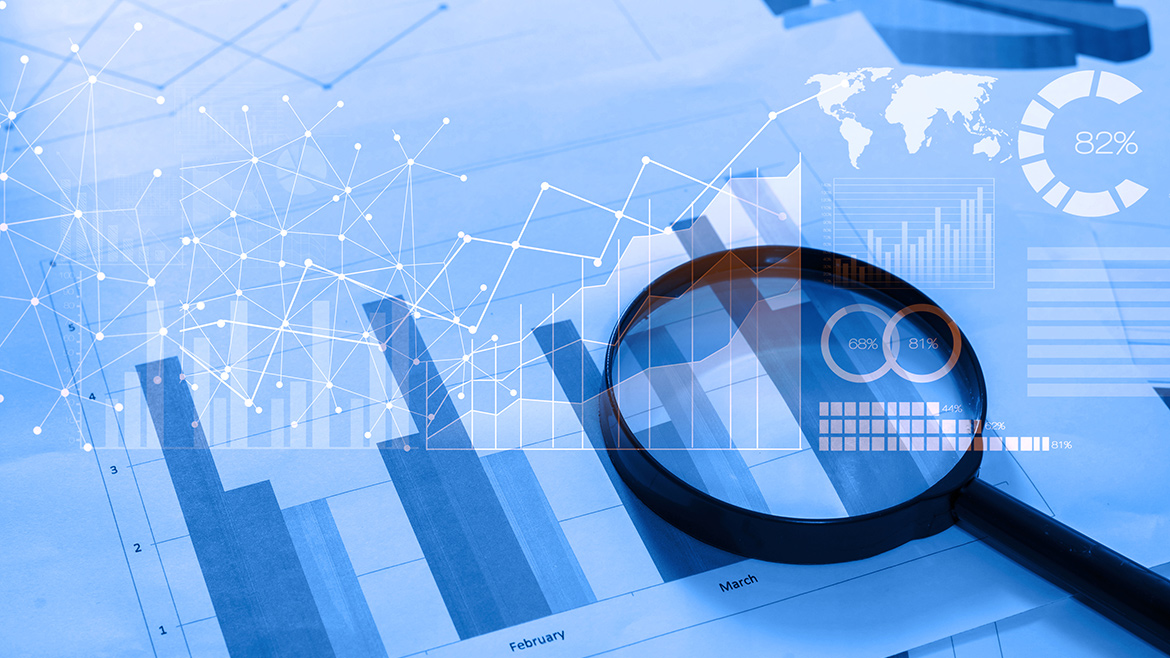 Magnifying glass and documents with analytics data lying on tablet