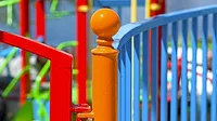 GI-456793305-1170x658.jpg Colorfully painted fence around a playground