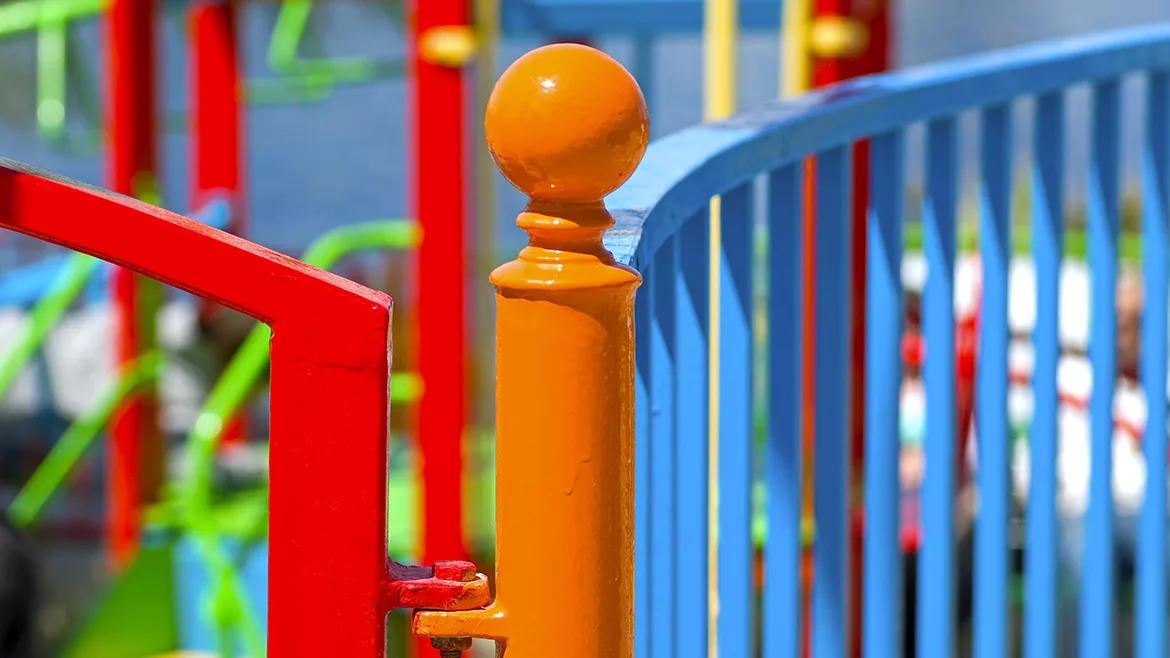Colorfully painted fence around a playground