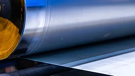 A detailed look at a shiny roll of metal, showcasing the intricacies and textures of the material used in the metal coating industry