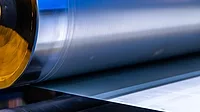 GI-2225069414-1170x658.jpg A detailed look at a shiny roll of metal, showcasing the intricacies and textures of the material used in the metal coating industry