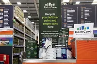 Paint Care hotograph of a PaintCare recycling station inside a hardware store, designed for collecting leftover paint and empty cans.
