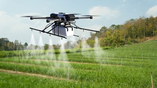 Drone spraying pesticide on wheat field