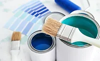 Paint Supplies and Color Selection Paint cans, paintbrushes, and color swatches for coating selection.