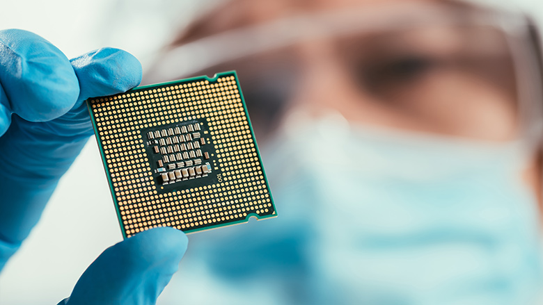 Selective focus of engineer holding computer microchip