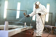 man spray painting