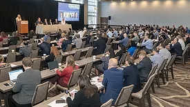 Attendees listening to a coatings industry panel discussion
