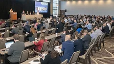 Attendees listening to a coatings industry panel discussion