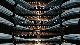 Detailed close-up view of fiber optic cables connected to network equipment inside a modern data center