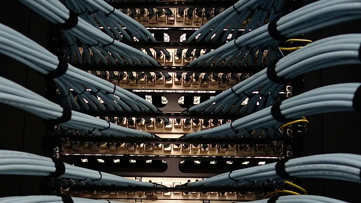 Detailed close-up view of fiber optic cables connected to network equipment inside a modern data center