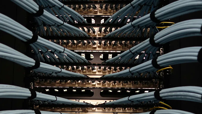Detailed close-up view of fiber optic cables connected to network equipment inside a modern data center
