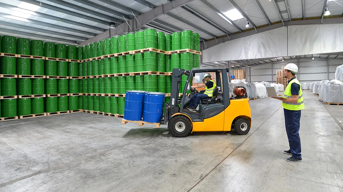 GI-2204104857-AltImage-1170x658.jpg Group of workers in the logistics industry work in a warehouse with chemicals
