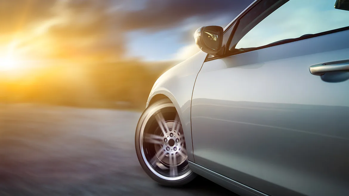 Car in motion at sunset