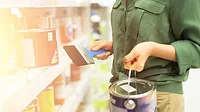 GI-1176621219-1170x658.jpg Woman choosing paint in paint store