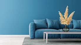 Modern living room design with empty blue painted wall and blue sofa