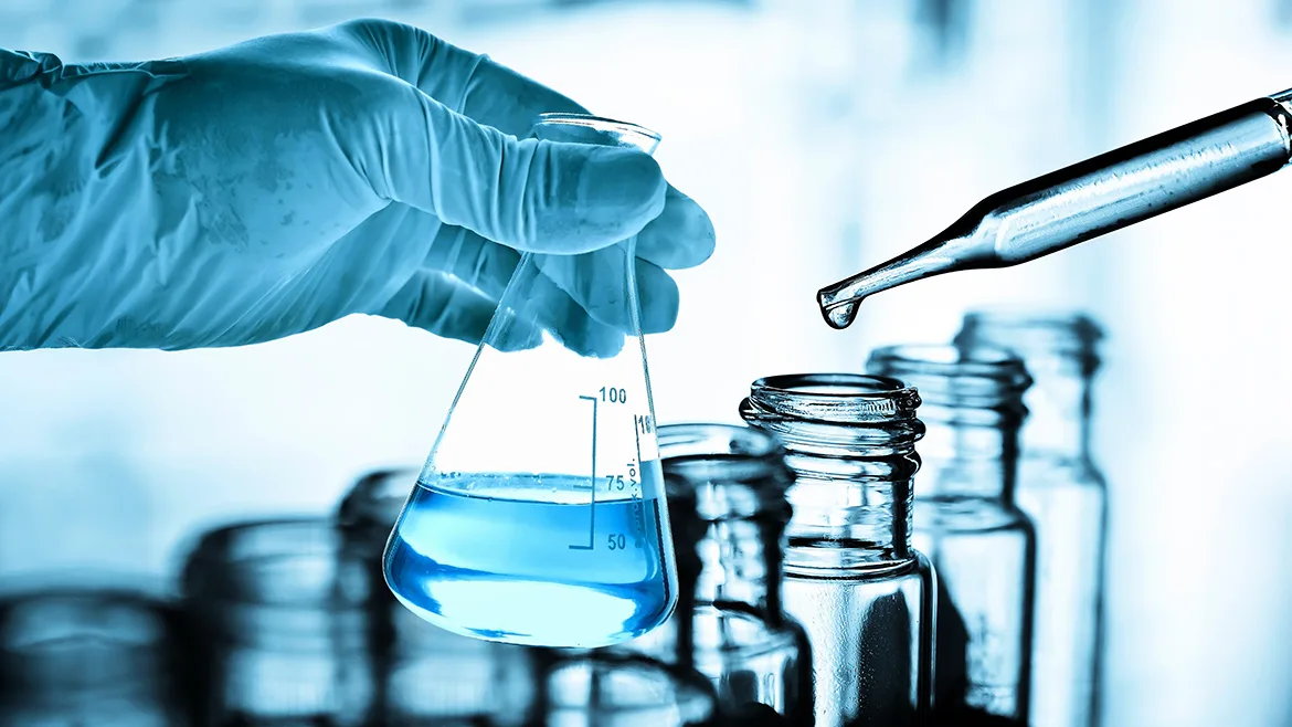 Scientist hand holding flask with laboratory background
