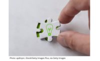 green light buln on puzzle piece being placed into a puzzle