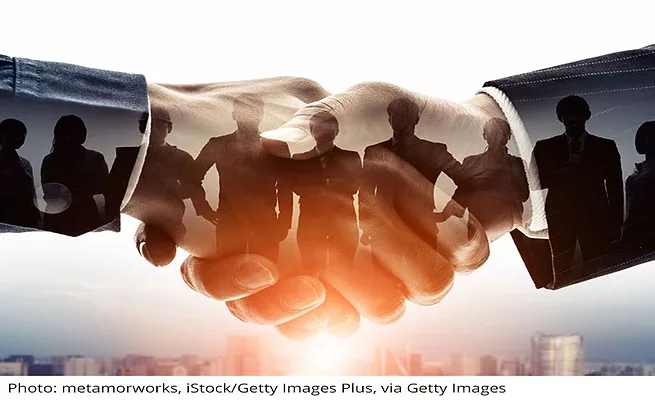 Distirubor agreements Company News Mergers a handshake over a horizon with individuals superimposed over the hands