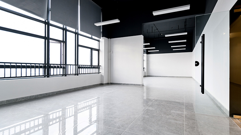 Empty office with glass window and resin-coated flooring