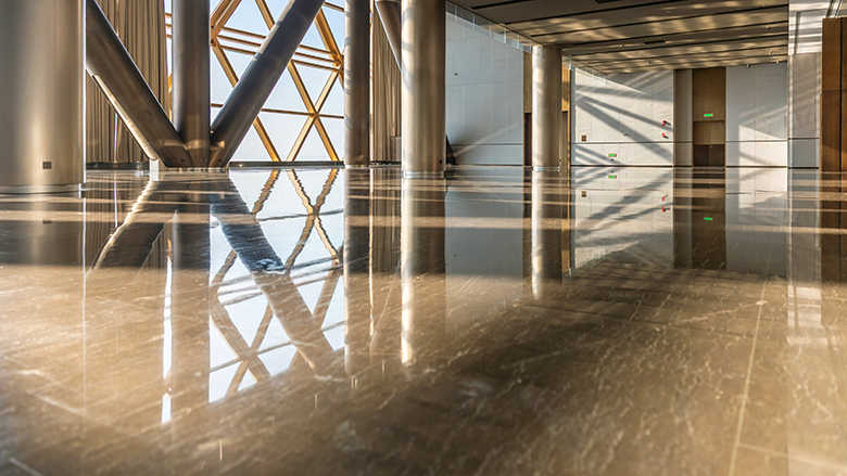 Sunlight streamed into the hall with shiny flooring