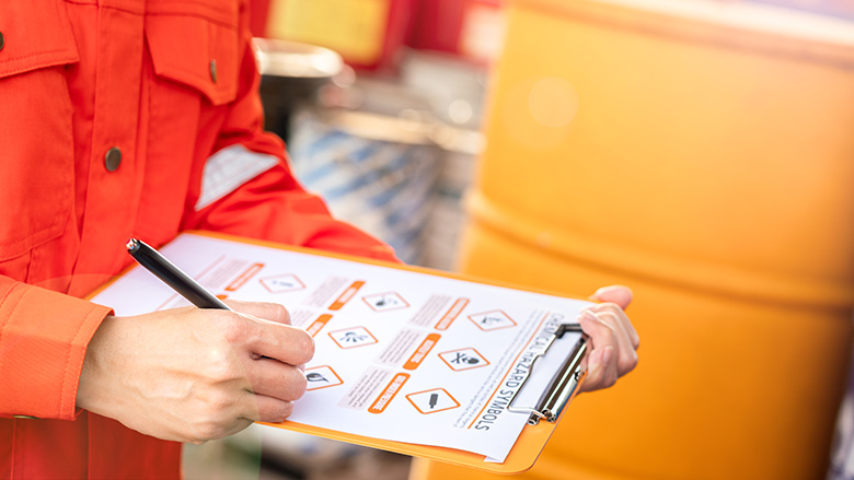 Environmental engineer is using hazardous material checklist form to correct the chemical safety at the factory storage area