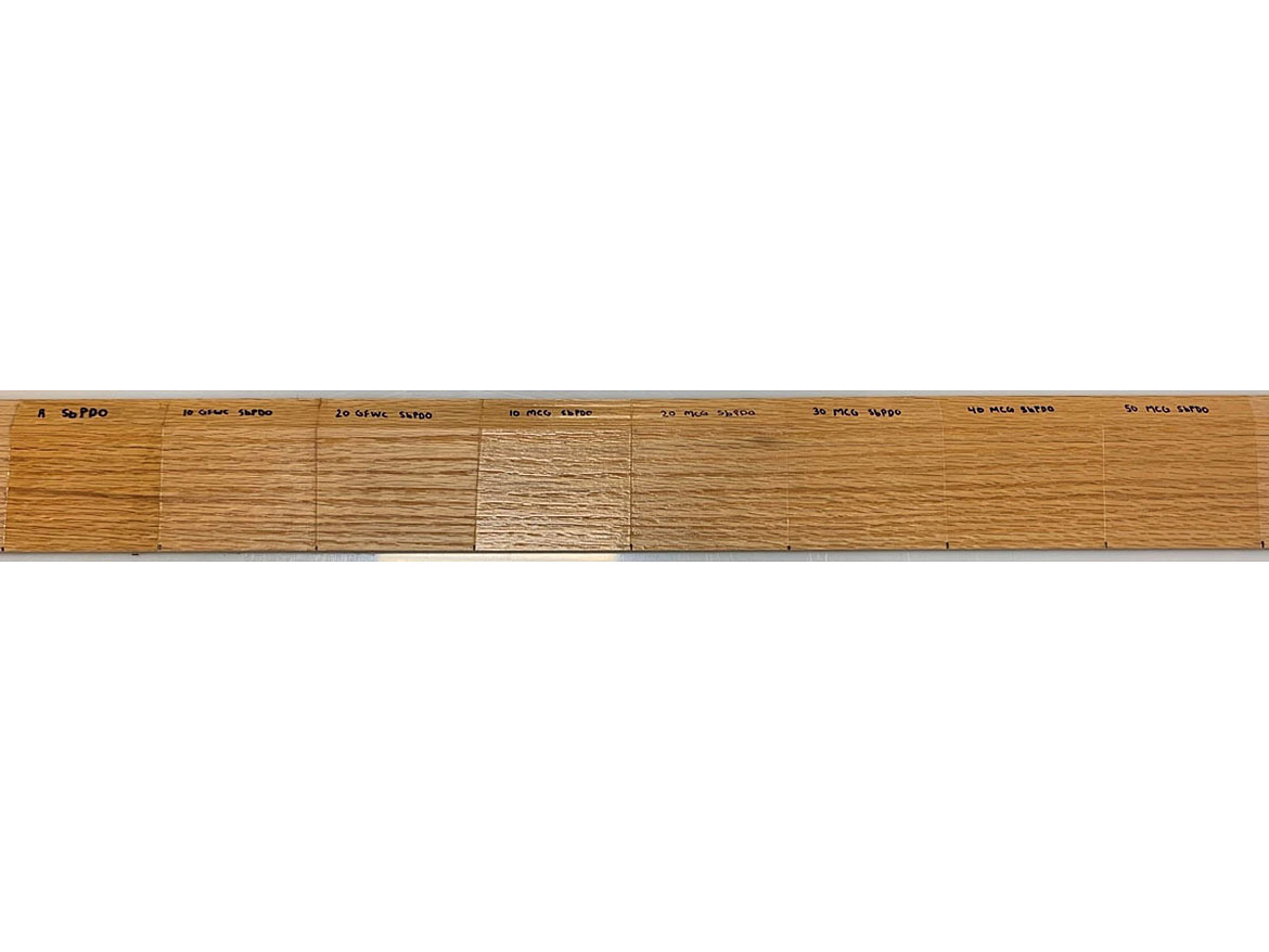 Photo of wood strip coated with referent PUDs: PUD+10% wet cake, PUD+12% wet cake, PUD+10% MCG, PUD+20% MCG, PUD+30% MCG, PUD+40% MCG, PUD+40% MCG (from left to right).