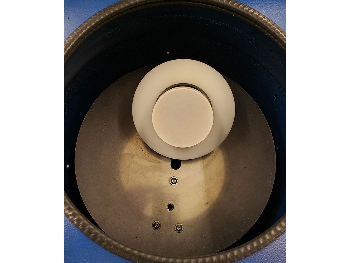 Sample holder placed in the basket of the dual axial centrifuge (paint sample).