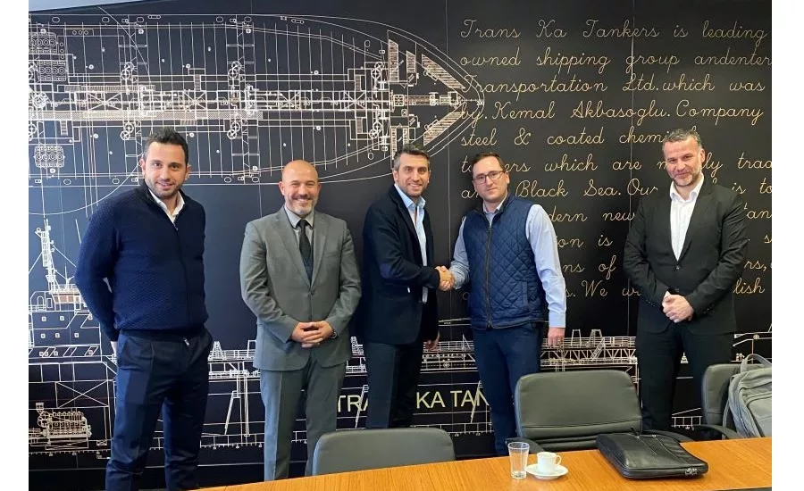 men shake hands standing at meeting table