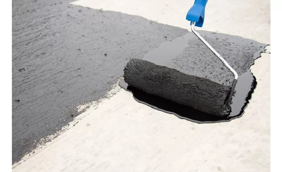 black paint being rolled onto a surface