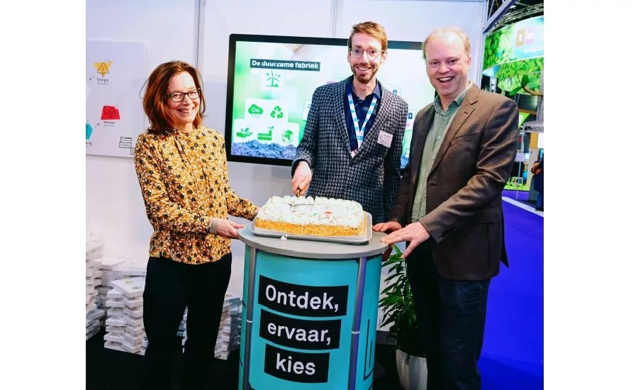 image of three people cutting a cake