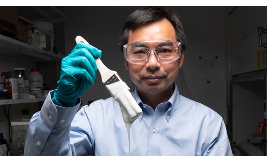 image of man in lab coat holding brush with whitest paint