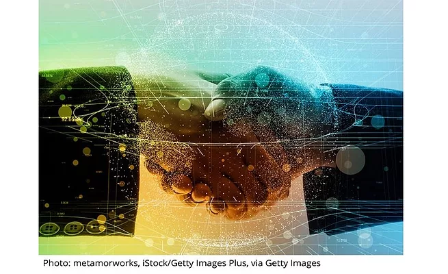 Company-News%2C-Mergers.jpg two hands shake with data overtop