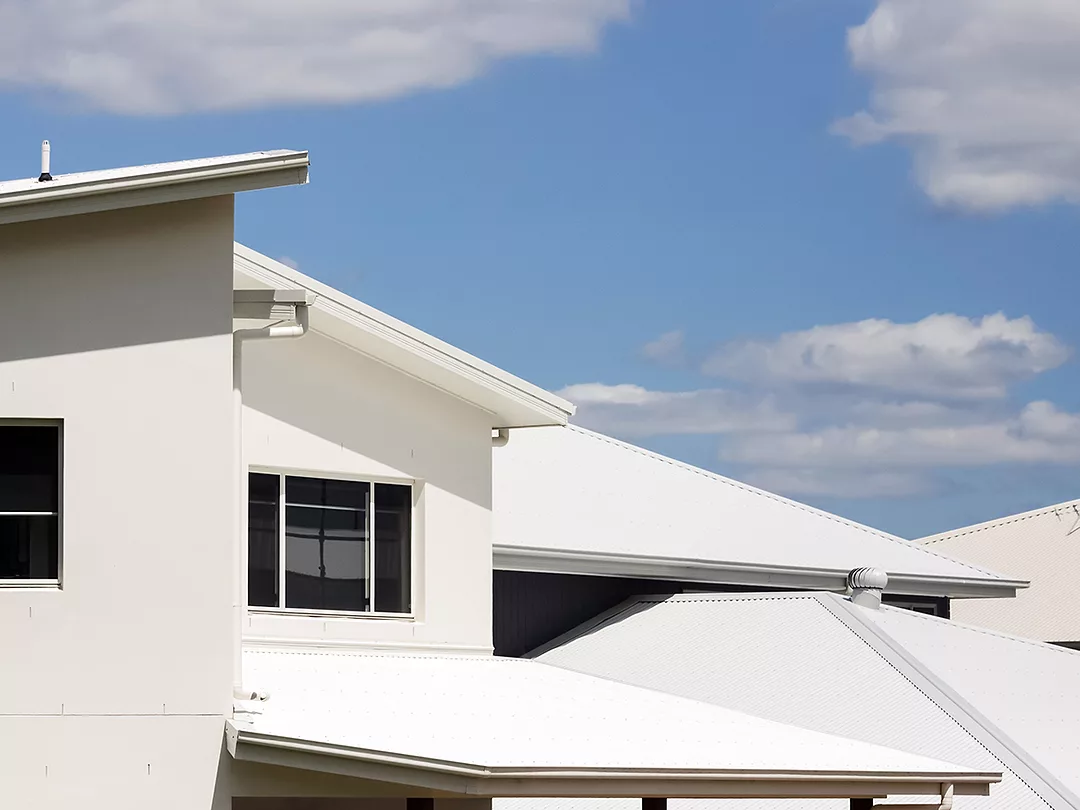 Closeup modern houses against blue sky background with copy space, full frame horizontal composition
