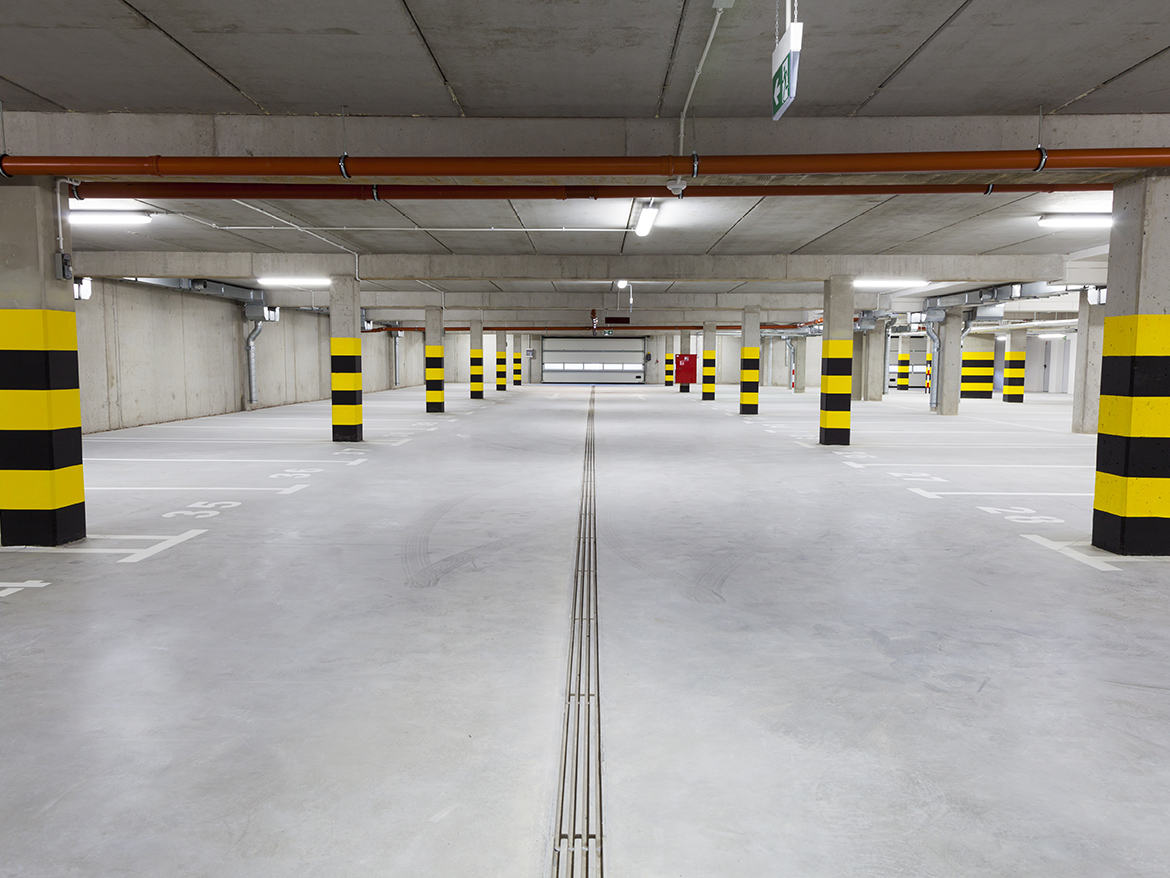 Empty underground garage with many parking places.