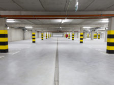 Empty underground garage with many parking places.
