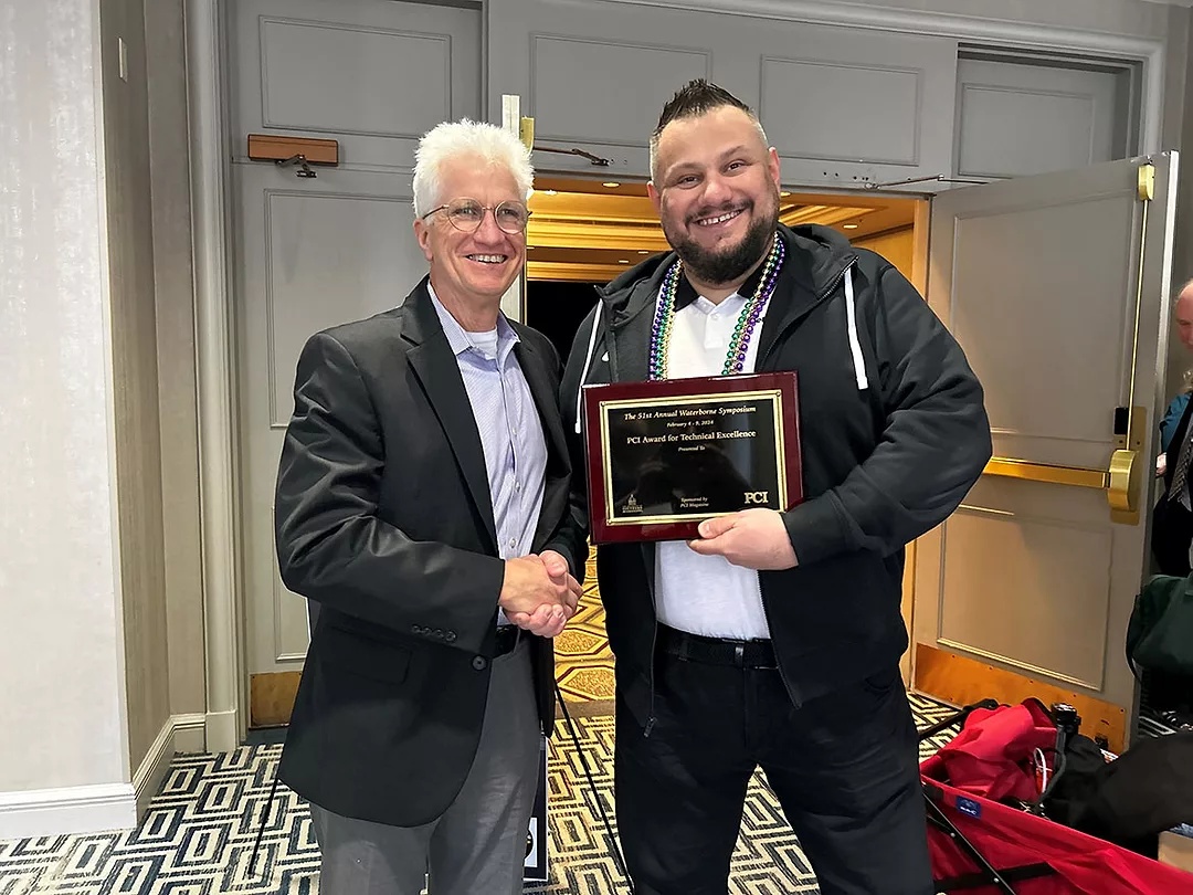 PCI’s Publisher, Tom Fowler, presents the PCI Award for Technical Excellence to Artur Palasz.