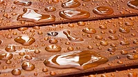 GI-184211298-1170x658.jpg A close up on a recently sealed cottage deck just after the summer rain.