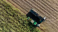 aerial top view of harvesting truck and field