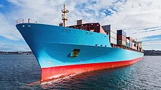 Aerial drone view of a container ship anchored in a harbor