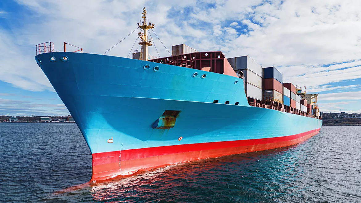 Aerial drone view of a container ship anchored in a harbor