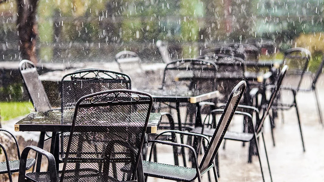 Rain falling on restaurant tables