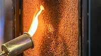 GI-2156901739-1170x658.jpg Close up of a flame torch testing flame retardant material, demonstrating fire resistance and safety in industrial applications