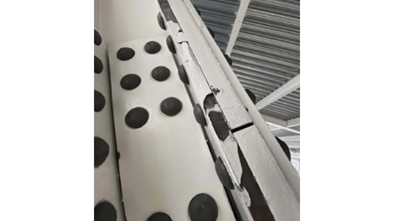 Brittle fracture of the intumescent PFP coating.