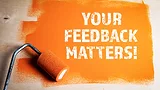 Orange painted wooden surface with paint roller and message in white: "Your Feedback Matters"