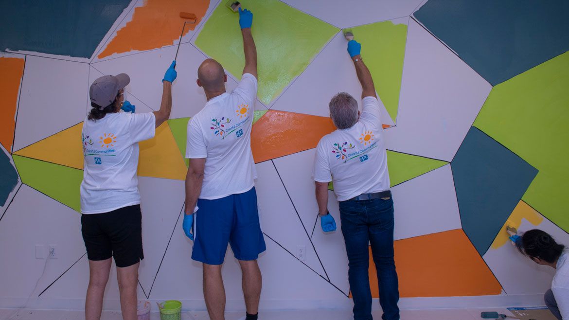 Photo of PPG employees painting mural