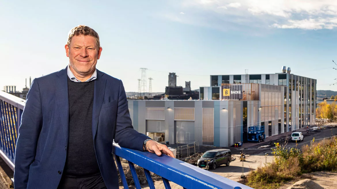 Photo of Kjetil Larsen standing in front of the Norner Polymer Exploration Centre