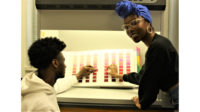 Picture of two students with a color chart