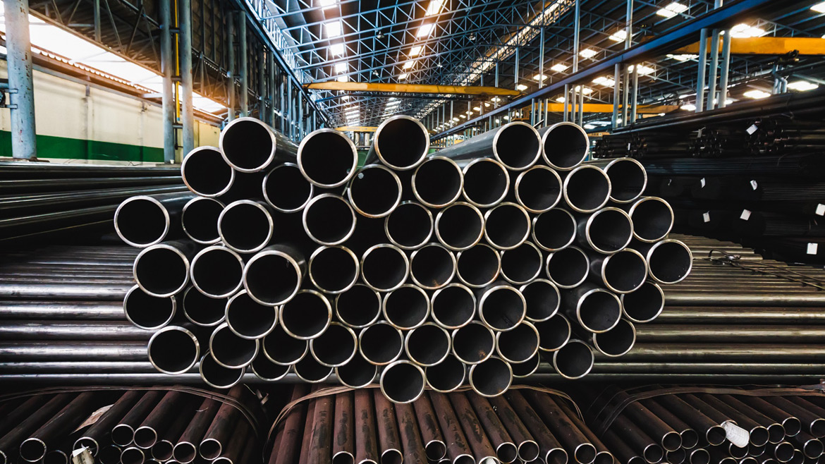 Image of a stack of metal pipes in a factory